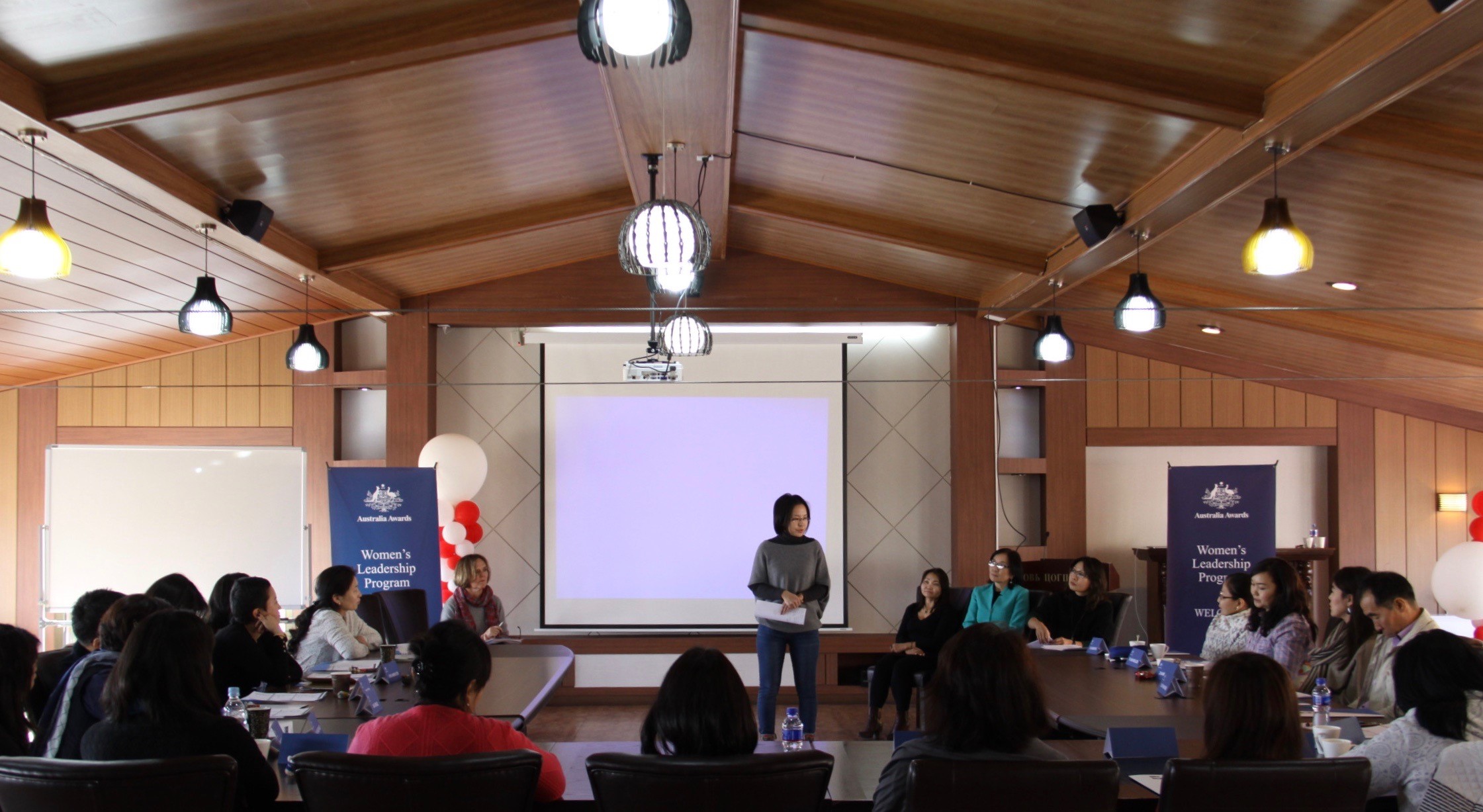Attendees of the three day Women's Leadership Program (WLP) Orientation Retreat attend a presentation.